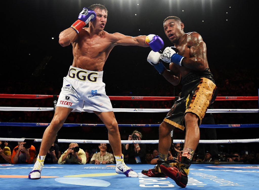 Boxer Gennady Golovkin (L) from Kazakhstan lands a punch on Willie Monroe Jr. of the US in the second round during their Middleweight World Championship bout at the Forum Arena in Los Angeles, California on May 16, 2015.  Golovkin won the fight by knocking out  Monroe Jr. in the sixth round.        AFP PHOTO / MARK RALSTON (Photo by MARK RALSTON / AFP)